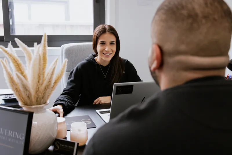 Support worker reviewing plan with participant at kitchen table